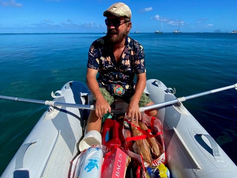 Sami rows back to our sailboat home with a full dingy